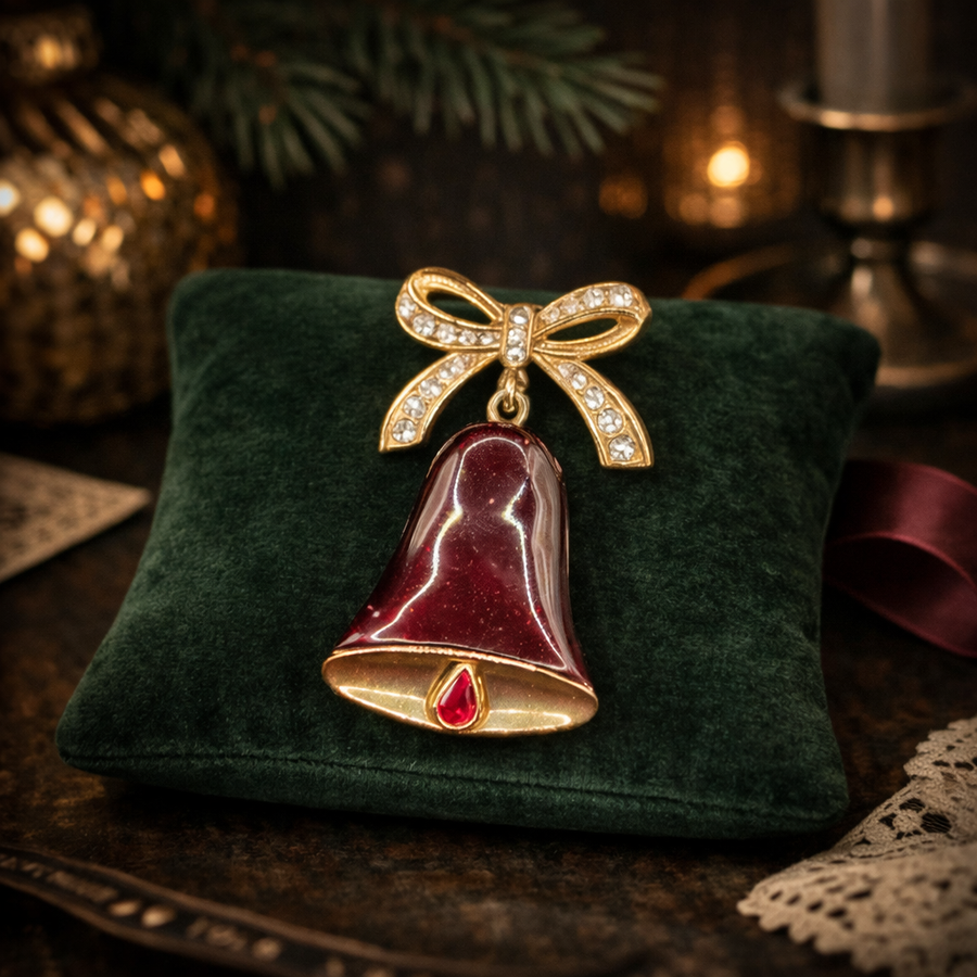 Gold-tone Christmas bell brooch with red enamel, rhinestone bow and red crystal accent