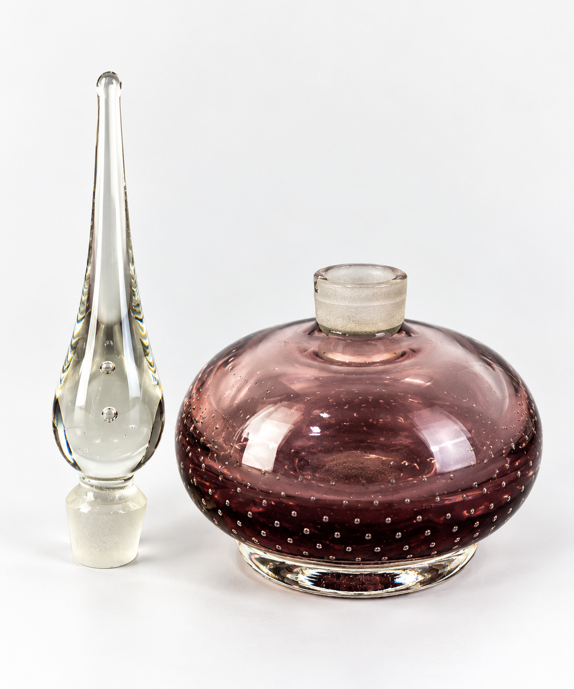 Amethyst-pink controlled bubble art glass bottle with clear foot and tall clear spire stopper, view 5