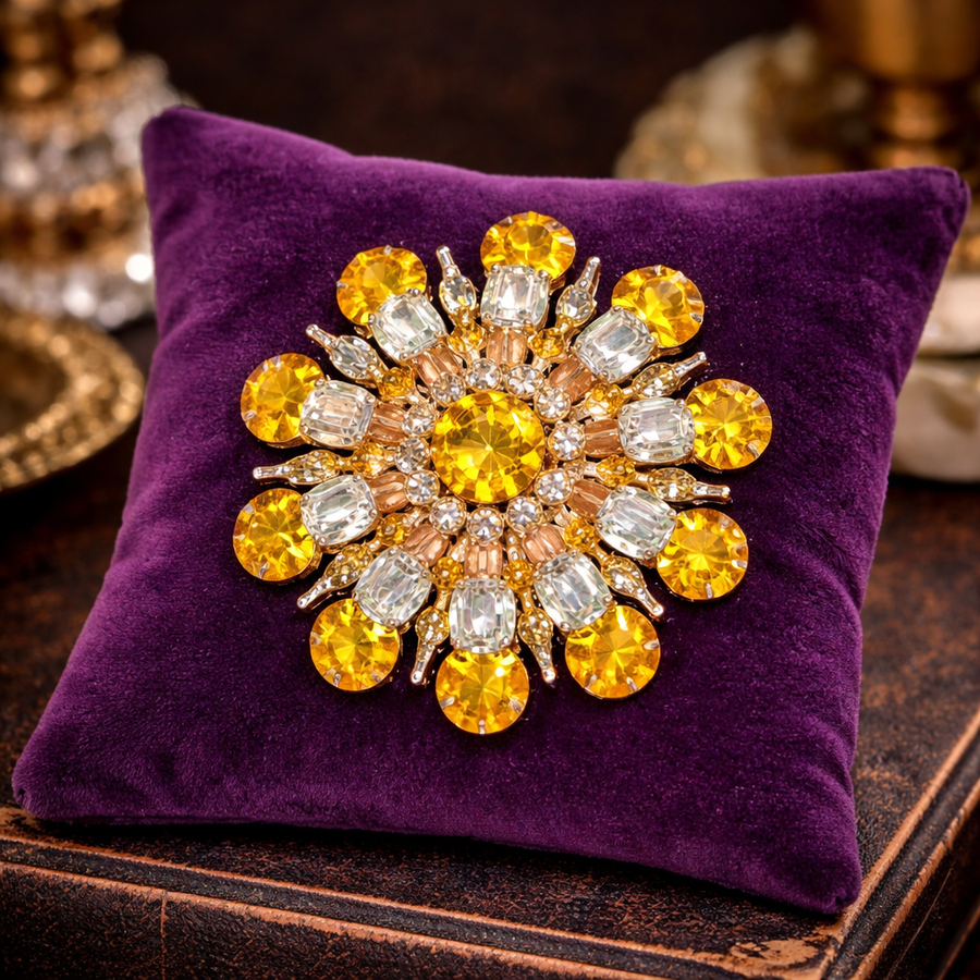 Gold-tone sunburst flower brooch with yellow and clear rhinestones in layered petals