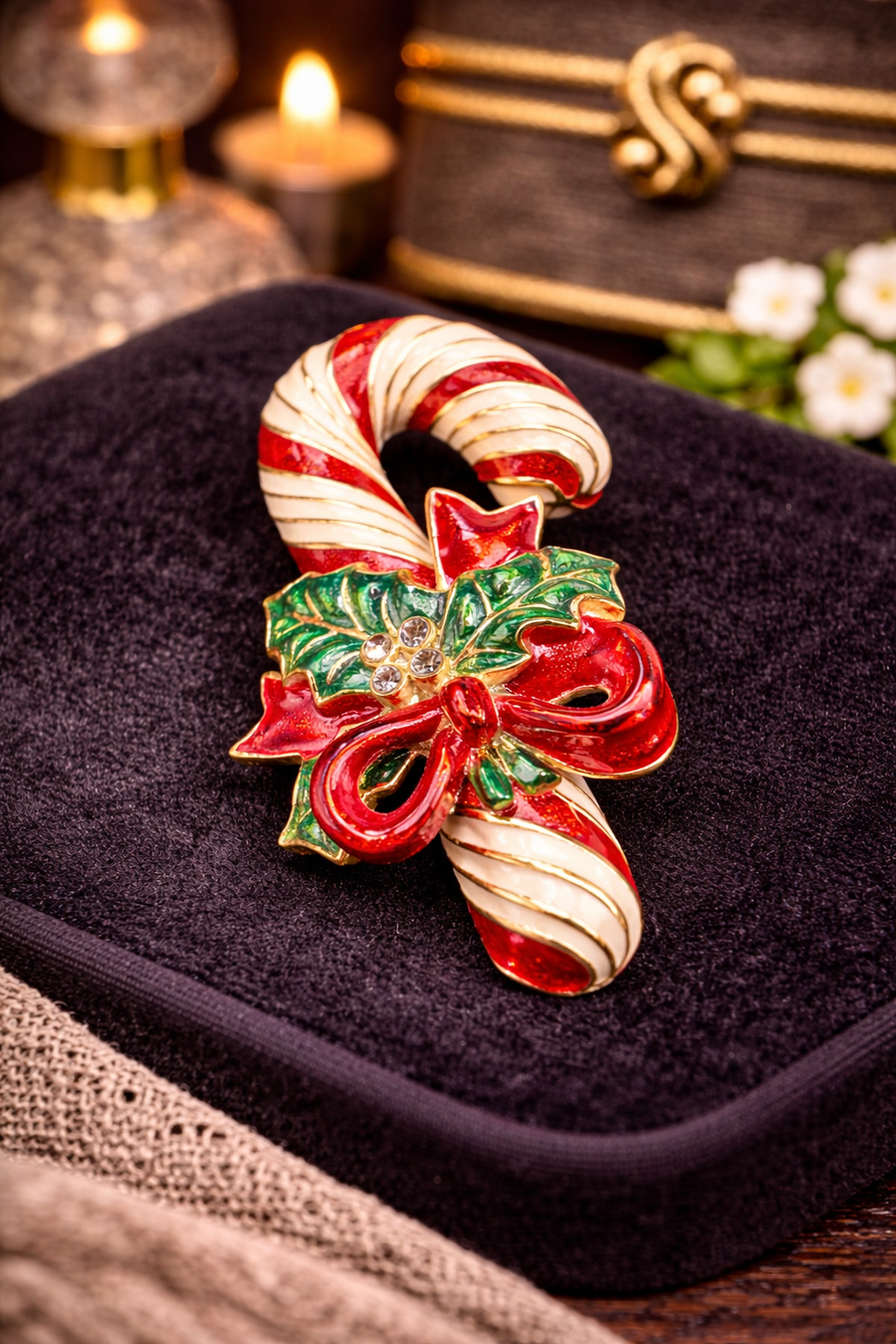 Red and white enamel candy cane Christmas brooch with green holly, red bow and clear stones