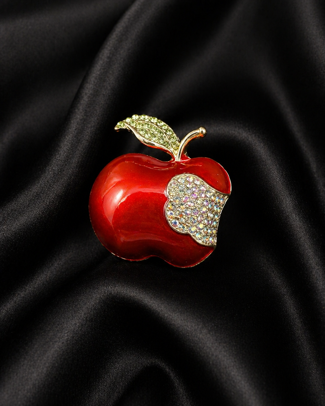 Red enamel-style apple brooch with crystal bite and crystal leaf