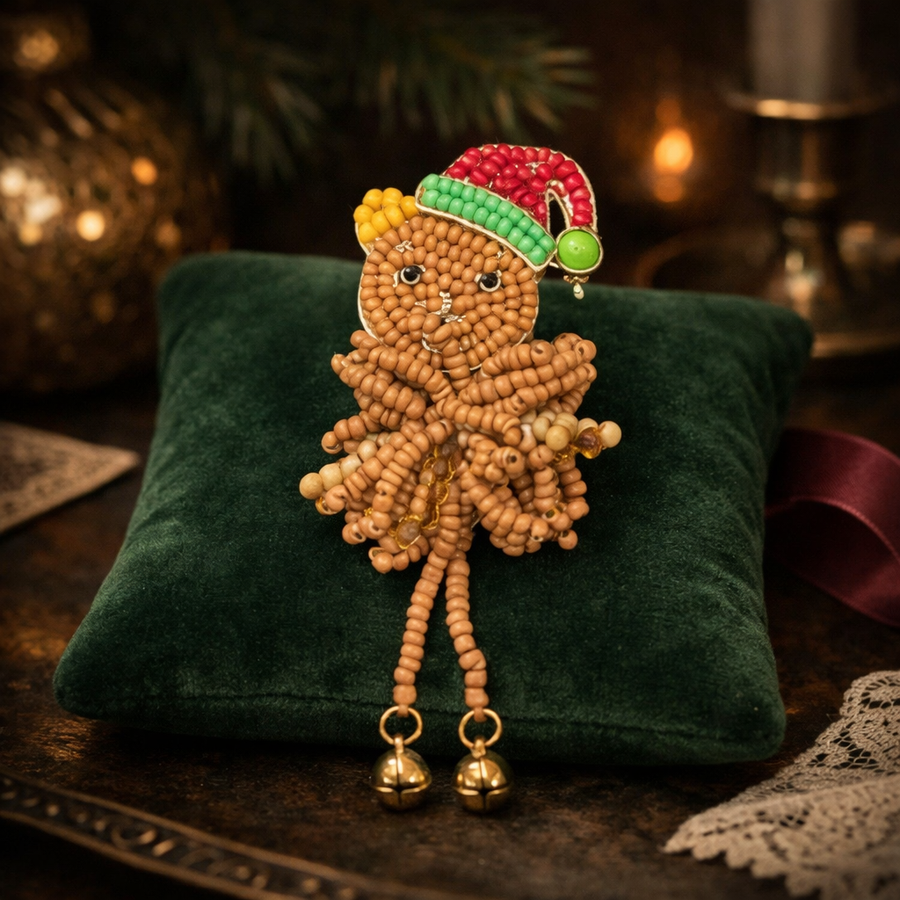 Beaded gingerbread man Christmas brooch with red and green Santa hat and dangling bead legs