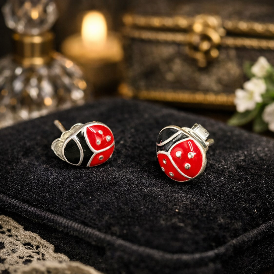 Silver-tone ladybug stud earrings with red and black enamel