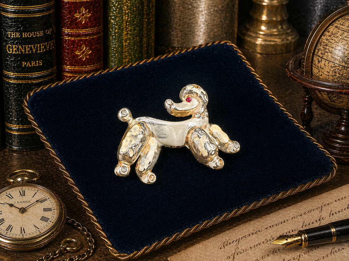 Gold-tone stylized poodle brooch with clear crystal accents and red eye