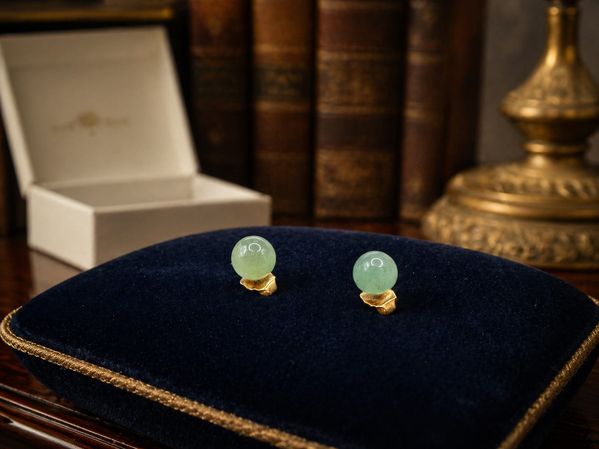 Avon gold-tone stud earrings with round soft green stones in original Avon box