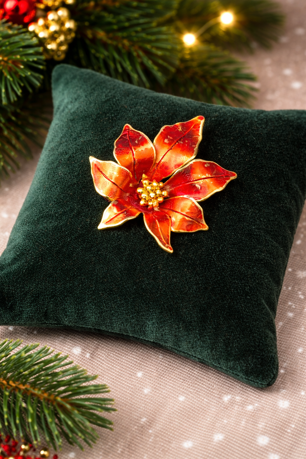 Signed Cerrito gold-tone poinsettia brooch with red enamel petals showing enamel wear