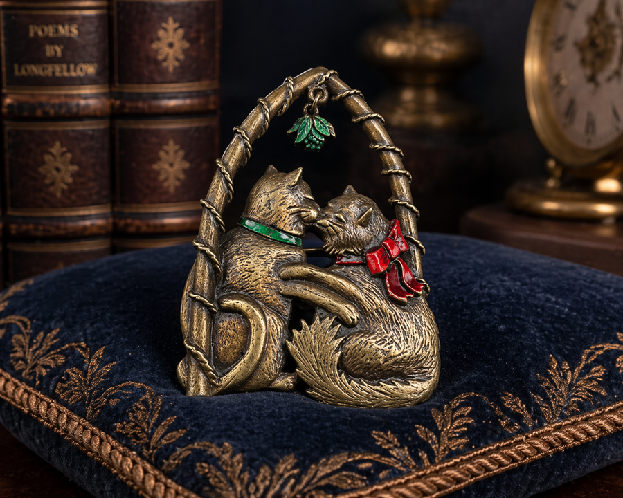 Signed JJ antique gold-tone brooch of two cats kissing under a mistletoe arch