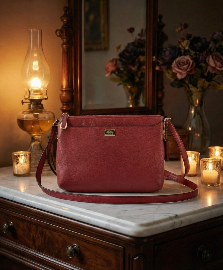 Red pebbled leather east-west swingpack crossbody bag with zip top