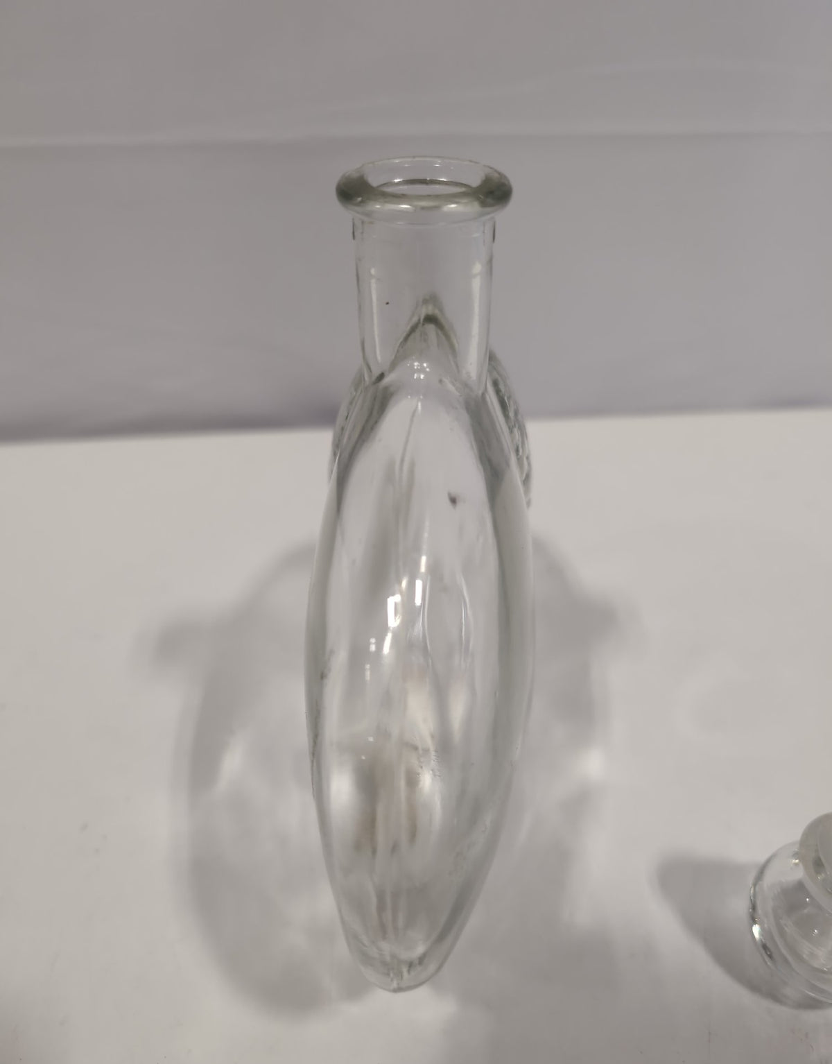 Clear glass flattened oval liqueur decanter with raised lemon decoration and ball stopper, view 5