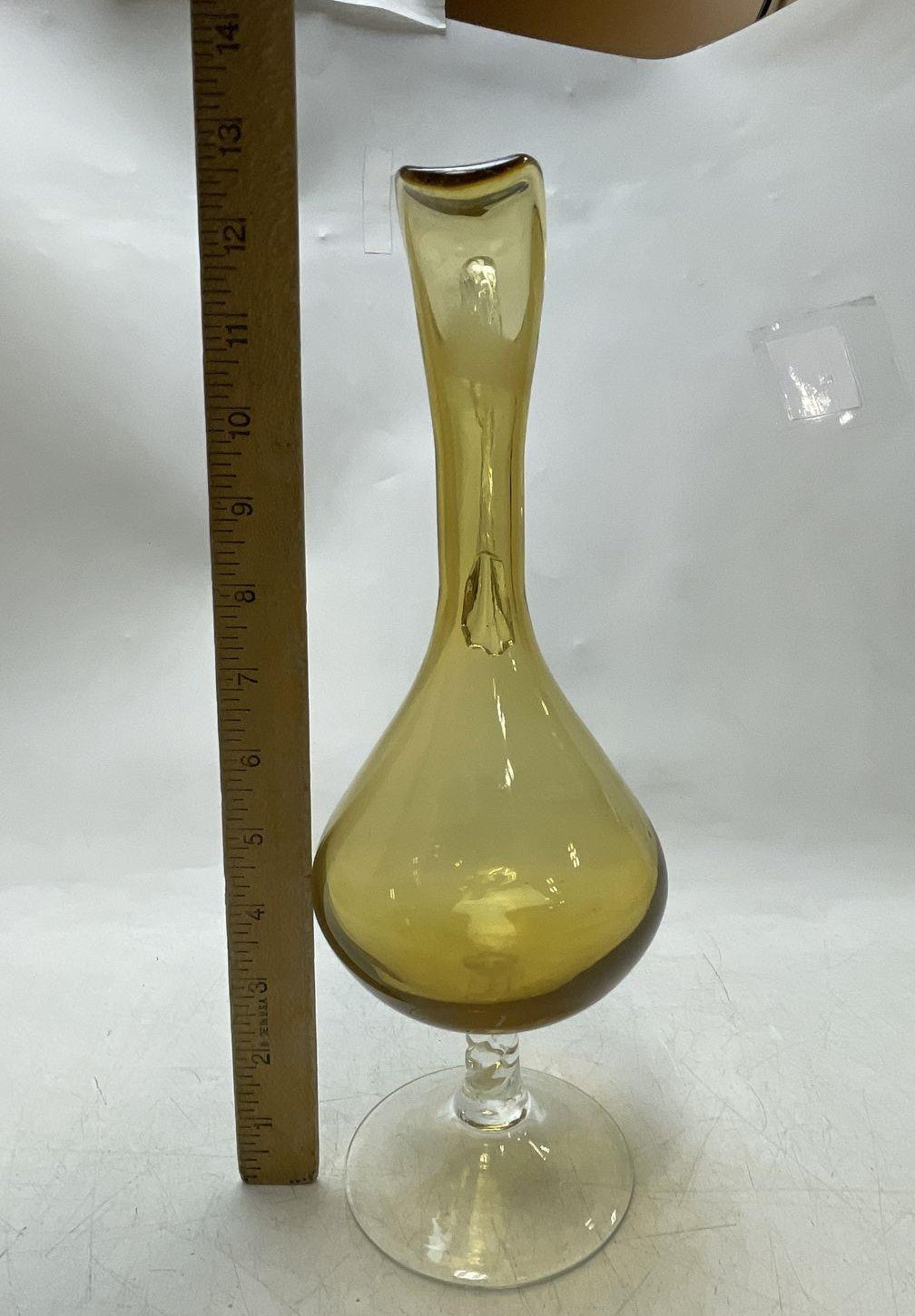 Amber glass decanter pitcher with flared spout, clear twisted stem and looping clear handle, view 3