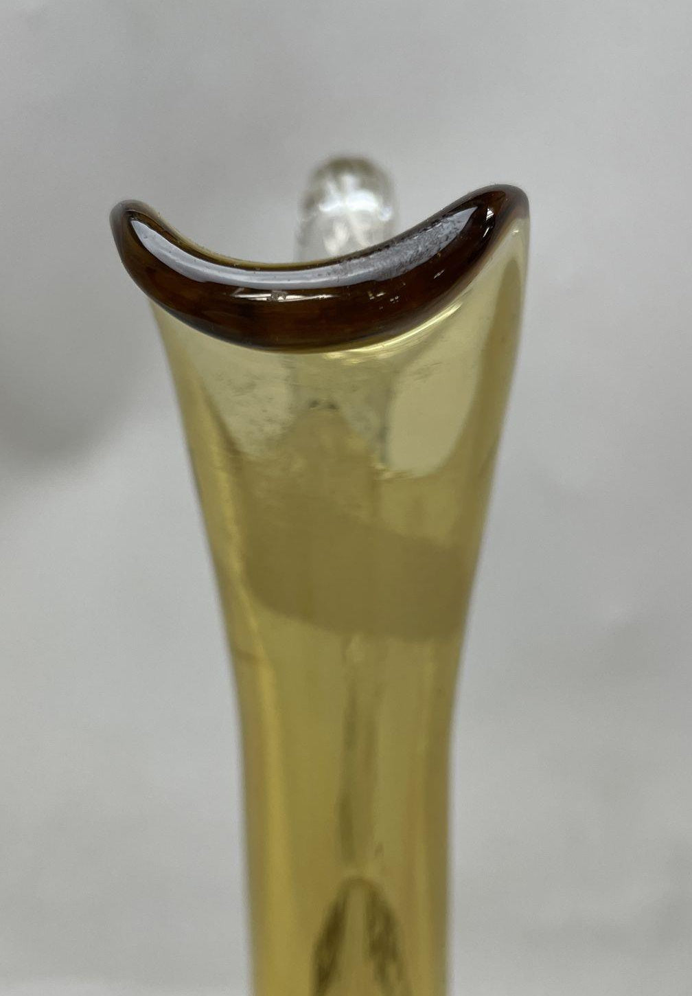 Amber glass decanter pitcher with flared spout, clear twisted stem and looping clear handle, view 6