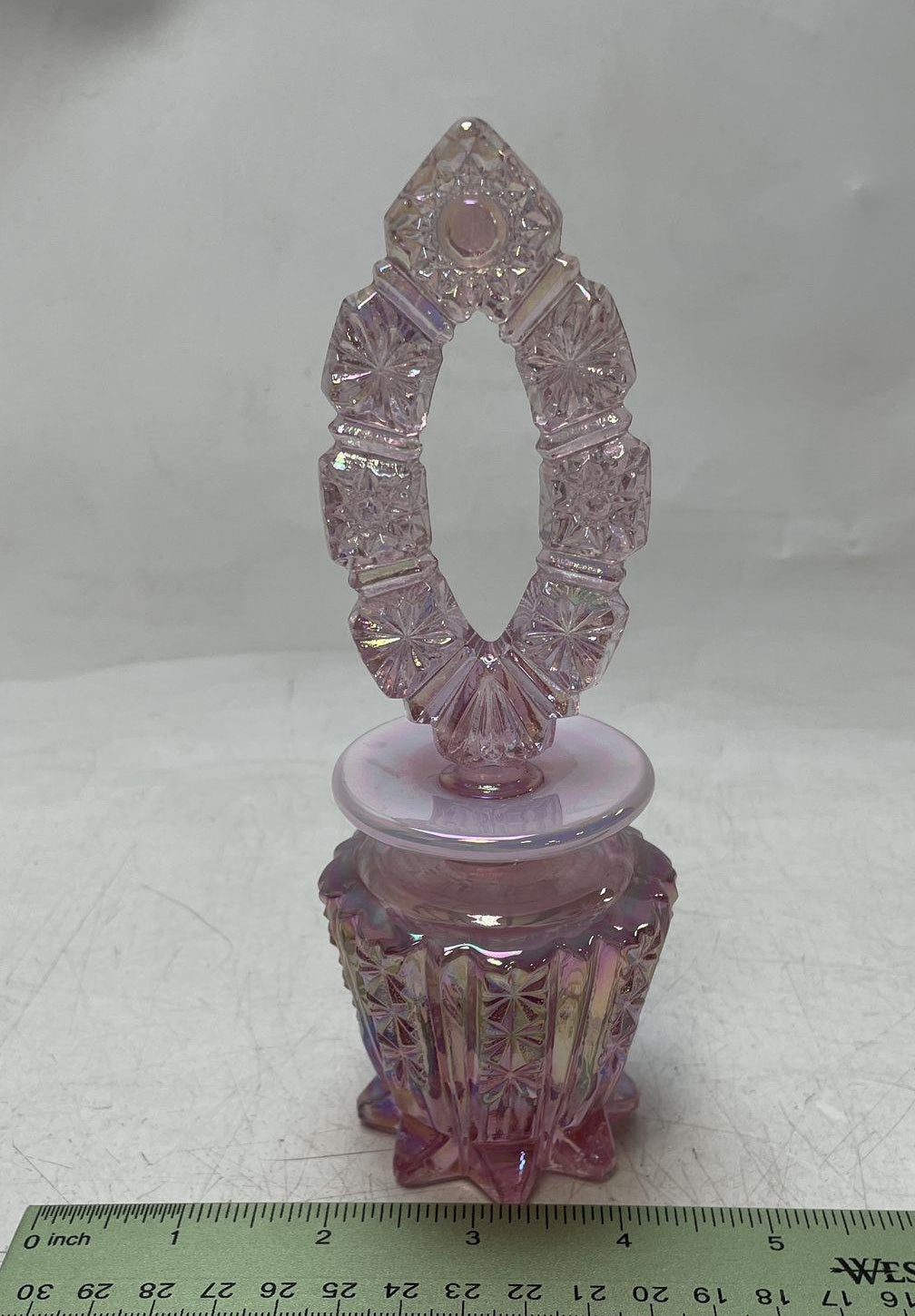 Pink iridescent carnival glass footed decanter with starburst panels and pierced oval stopper, view 4