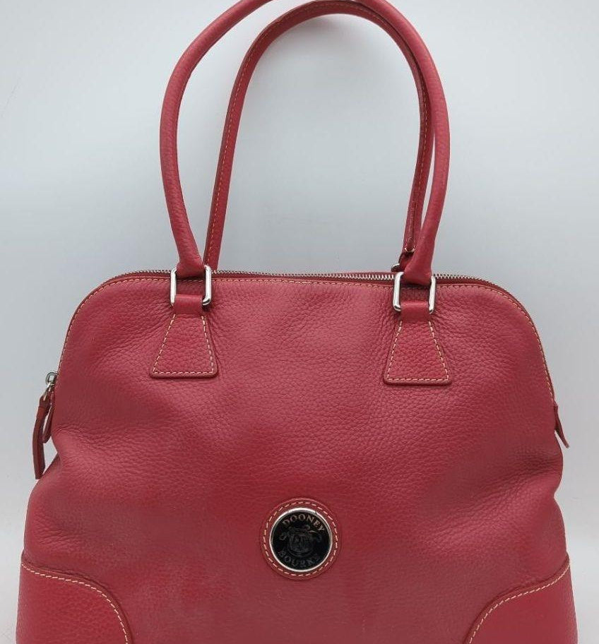 Dooney and Bourke red pebbled leather domed satchel with cream contrast stitching and rolled handles, view 2