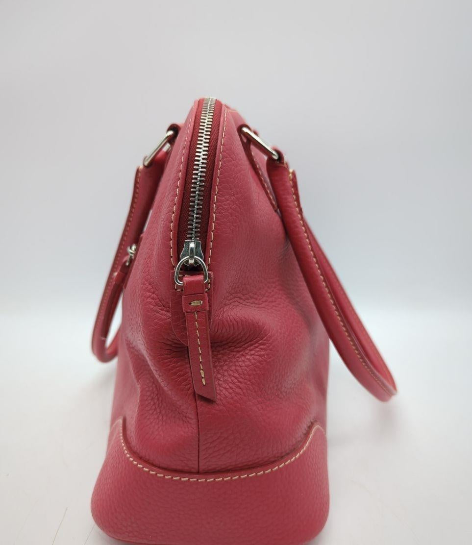 Dooney and Bourke red pebbled leather domed satchel with cream contrast stitching and rolled handles, view 3
