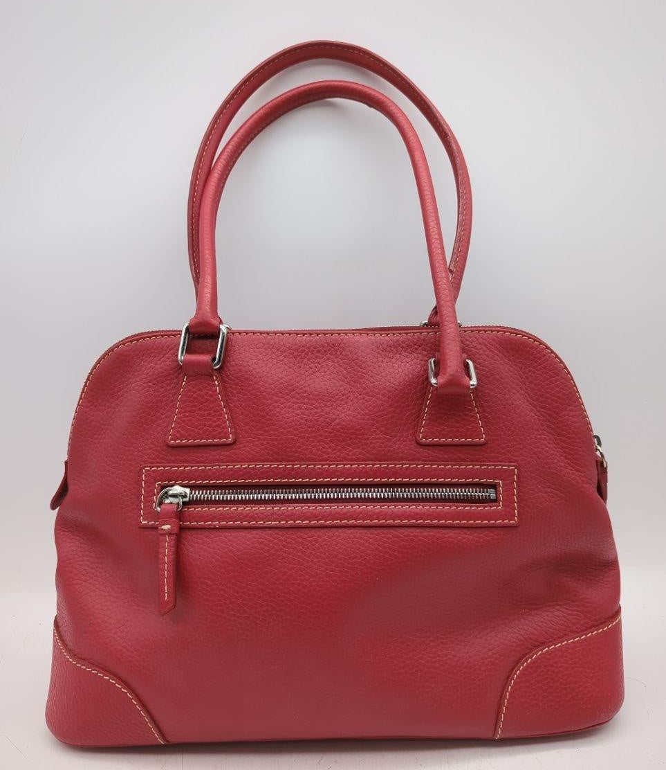 Dooney and Bourke red pebbled leather domed satchel with cream contrast stitching and rolled handles, view 4