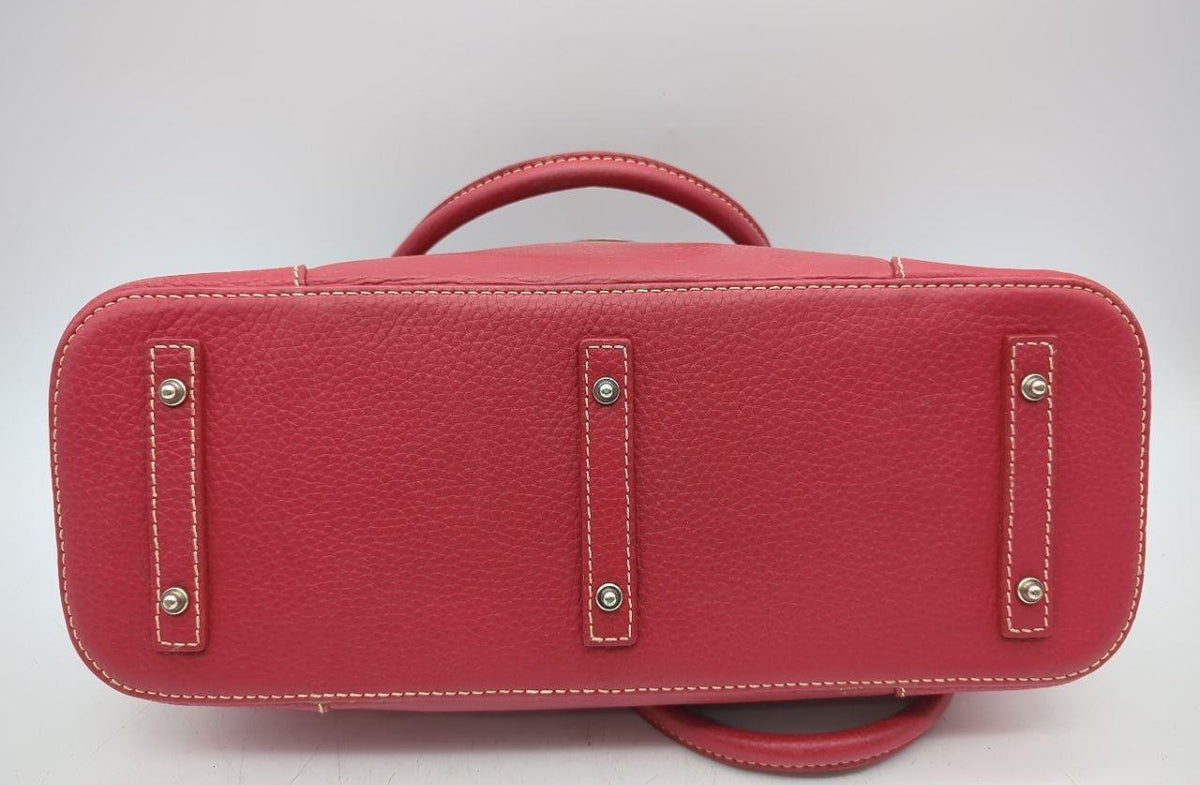 Dooney and Bourke red pebbled leather domed satchel with cream contrast stitching and rolled handles, view 6