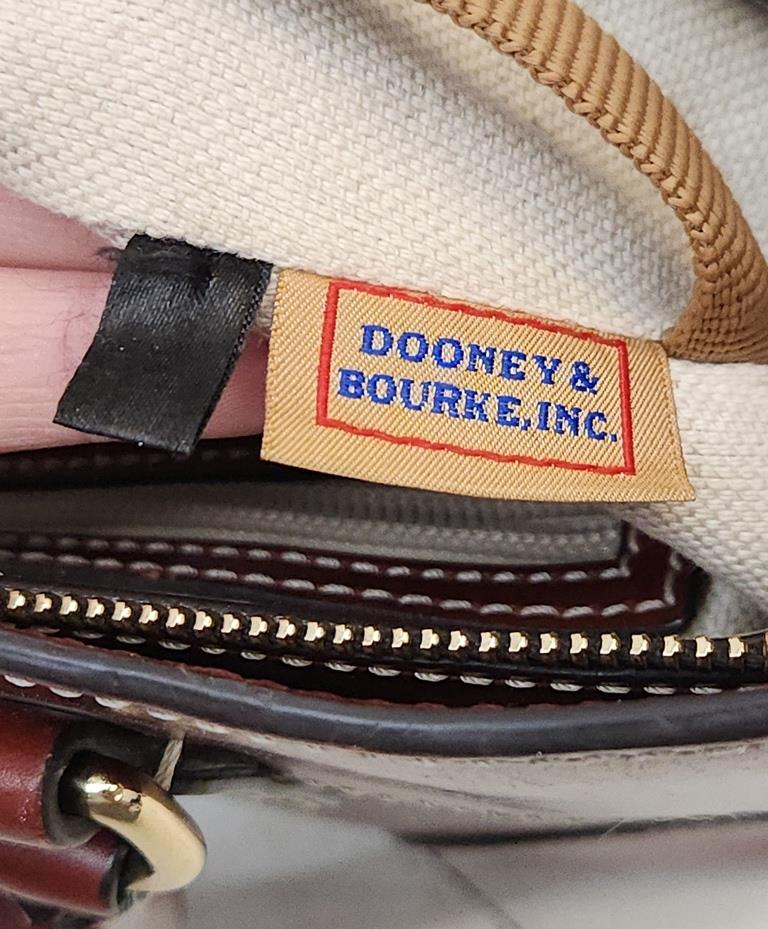 Dooney & Bourke reddish brown smooth leather satchel with rolled handles and crossbody strap, view 11