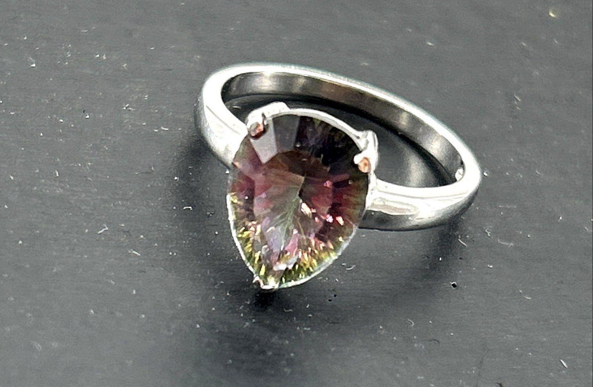 Silver cocktail ring with pear-shaped iridescent stone in prong setting, view 3