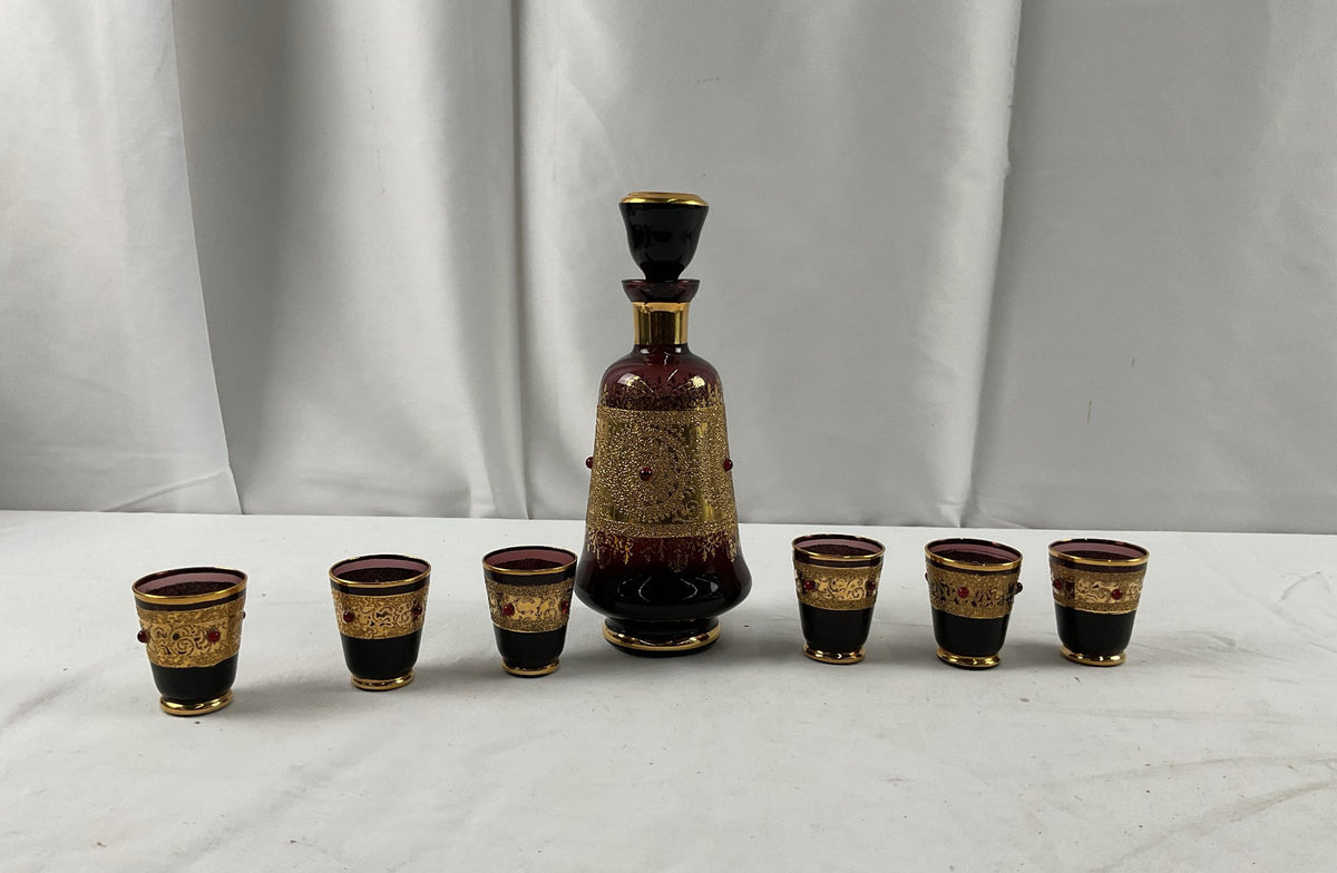 Burgundy glass decanter with raised gold scrollwork, red cabochons and six shot glasses, view 2
