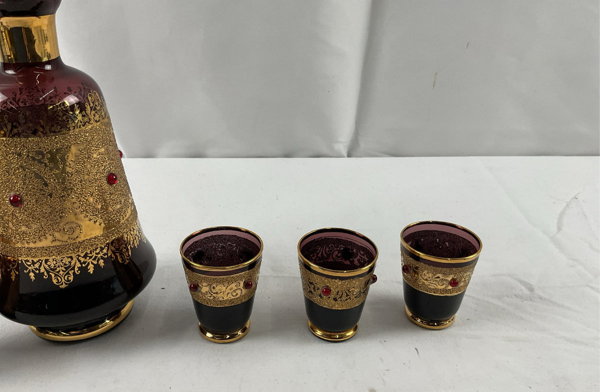 Burgundy glass decanter with raised gold scrollwork, red cabochons and six shot glasses, view 4