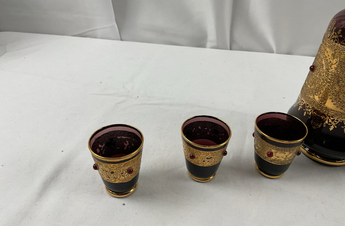 Burgundy glass decanter with raised gold scrollwork, red cabochons and six shot glasses, view 5