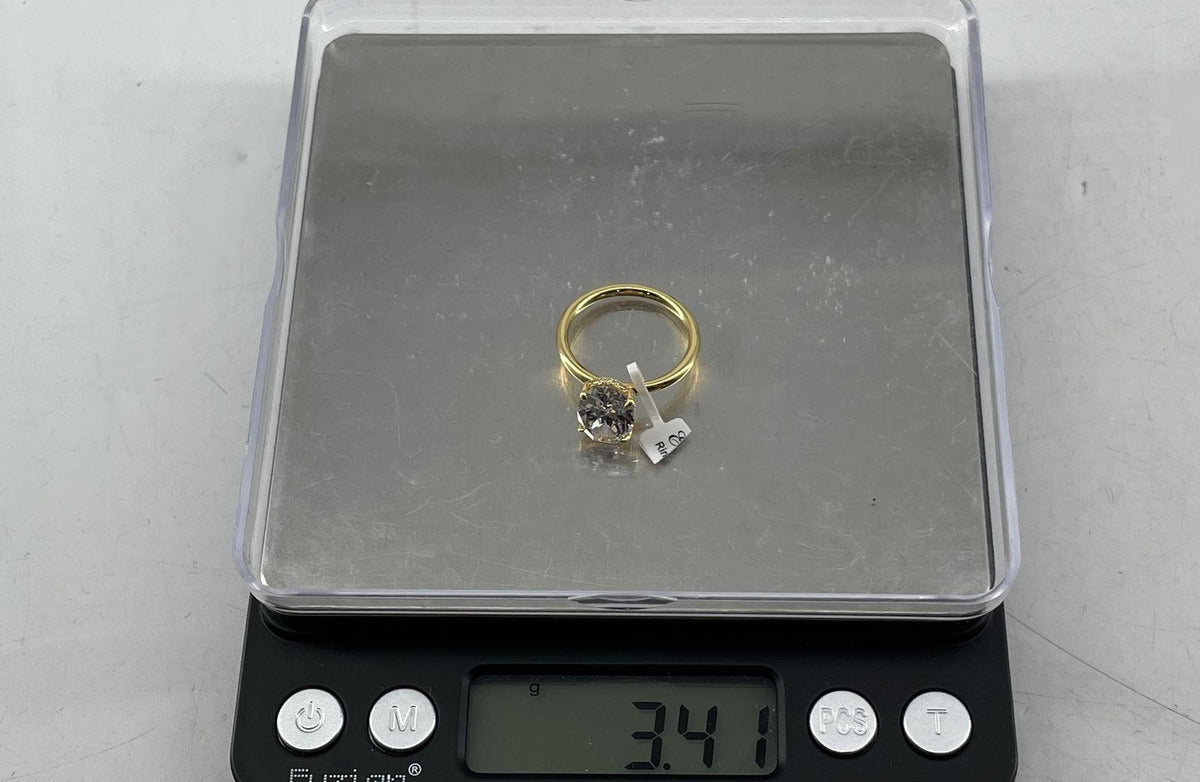 Gold-tone solitaire ring with large oval clear stone in four split prongs, view 8