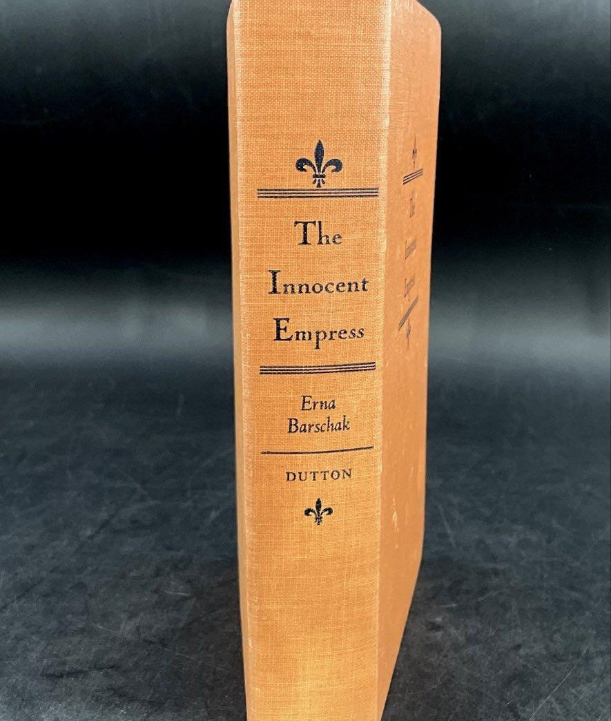 The Innocent Empress by Erna Barschak, orange-tan cloth hardcover with fleur-de-lis stamping, view 3