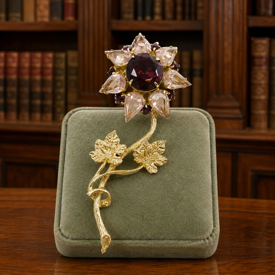 Gold-tone long stem flower brooch with pale pink pear rhinestone petals and ruby-red center