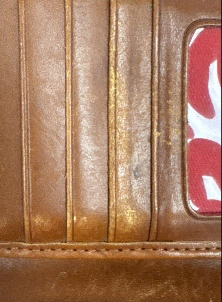 Dooney and Bourke red-brown pebbled envelope wallet with gold-tone 1975 plaque, view 7