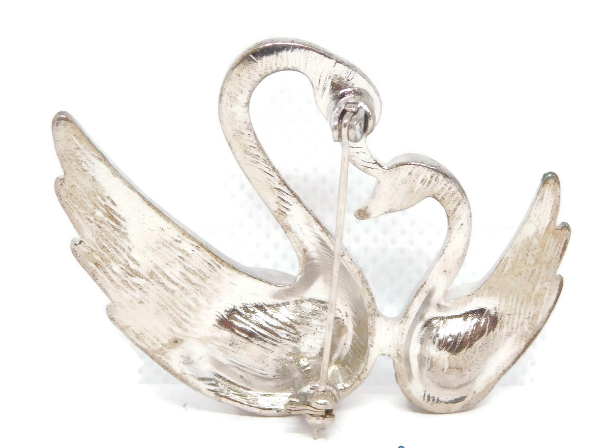 Silver-tone brooch of two swans head to head with clear rhinestone bodies and pavé wings, view 3