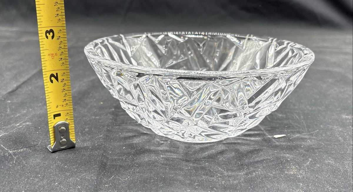 Clear rock cut glass serving bowl with faceted sides beside a blue presentation box, view 4