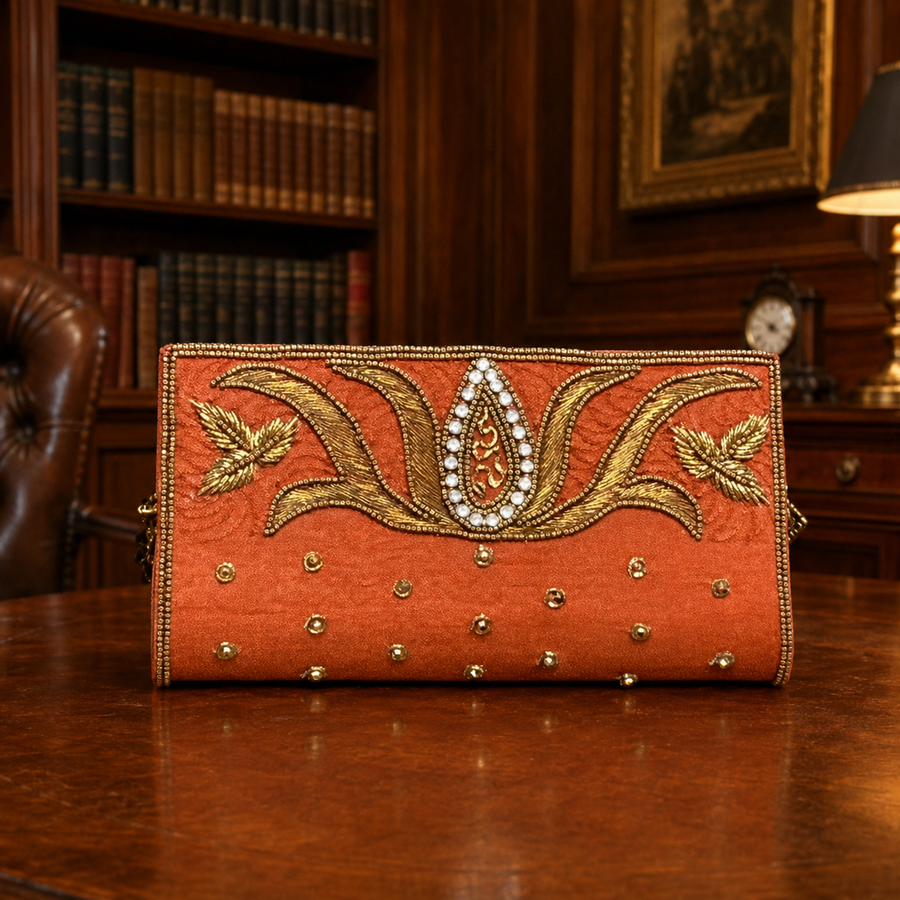 Burnt orange shagun money envelope with gold embroidery, beadwork and jeweled floral center