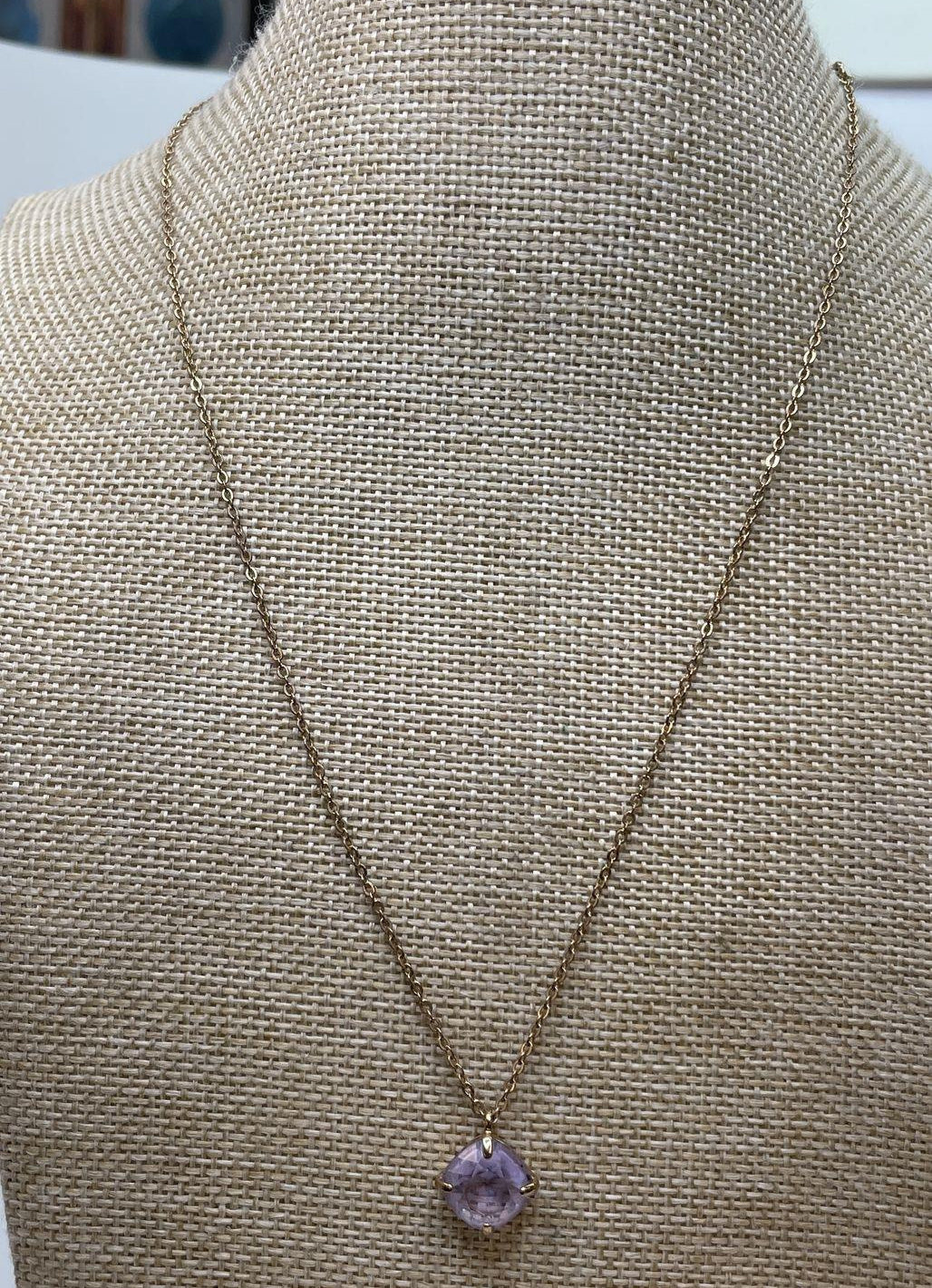 Gold-tone necklace with a single faceted lavender purple crystal pendant, view 2
