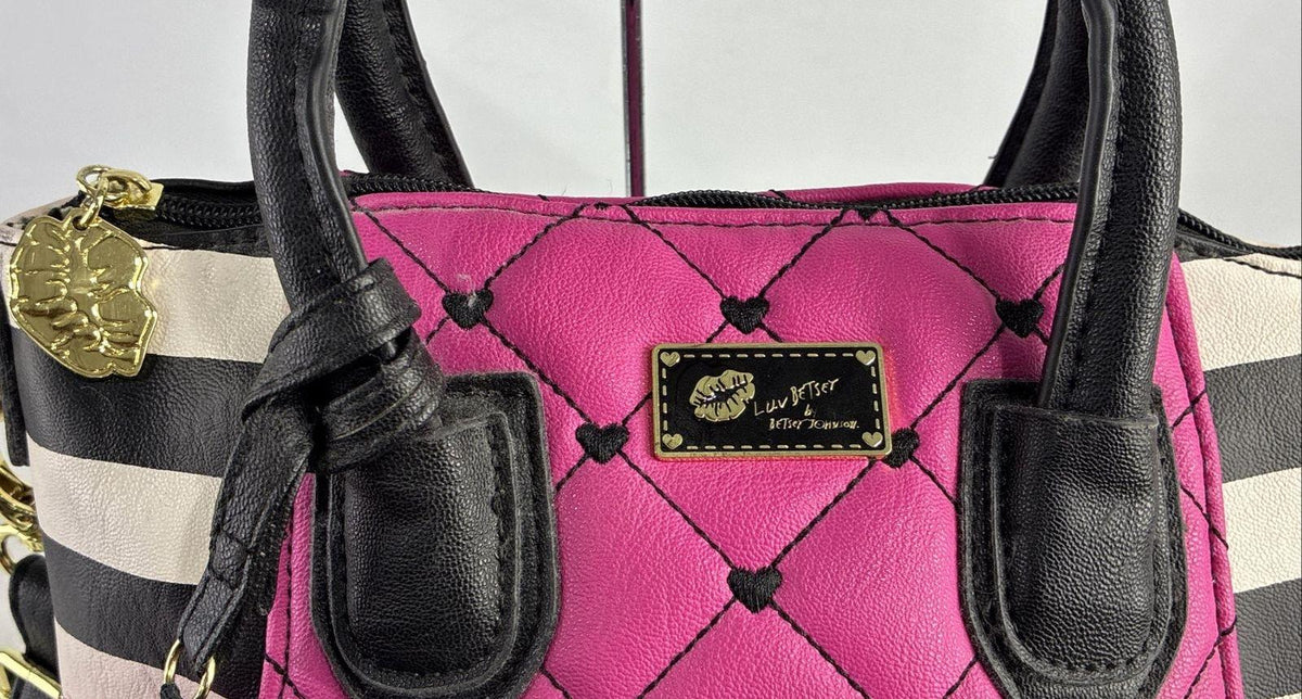 Betsey Johnson magenta quilted heart stitch crossbody bag with striped side panels and pom pom charm, view 3