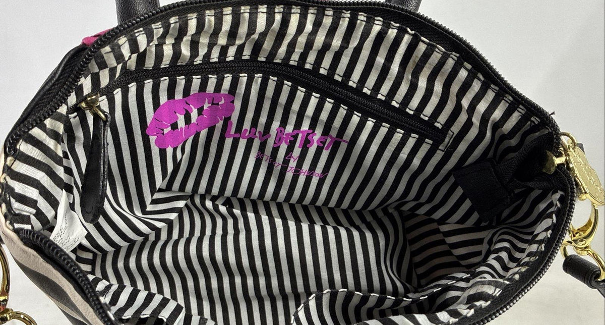 Betsey Johnson magenta quilted heart stitch crossbody bag with striped side panels and pom pom charm, view 6