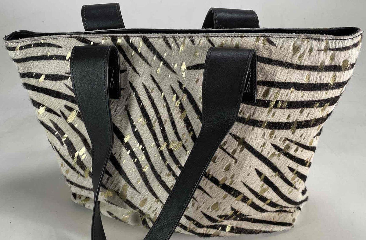 Black and cream zebra print hair-on texture tote with gold splatter and black shoulder straps, view 4