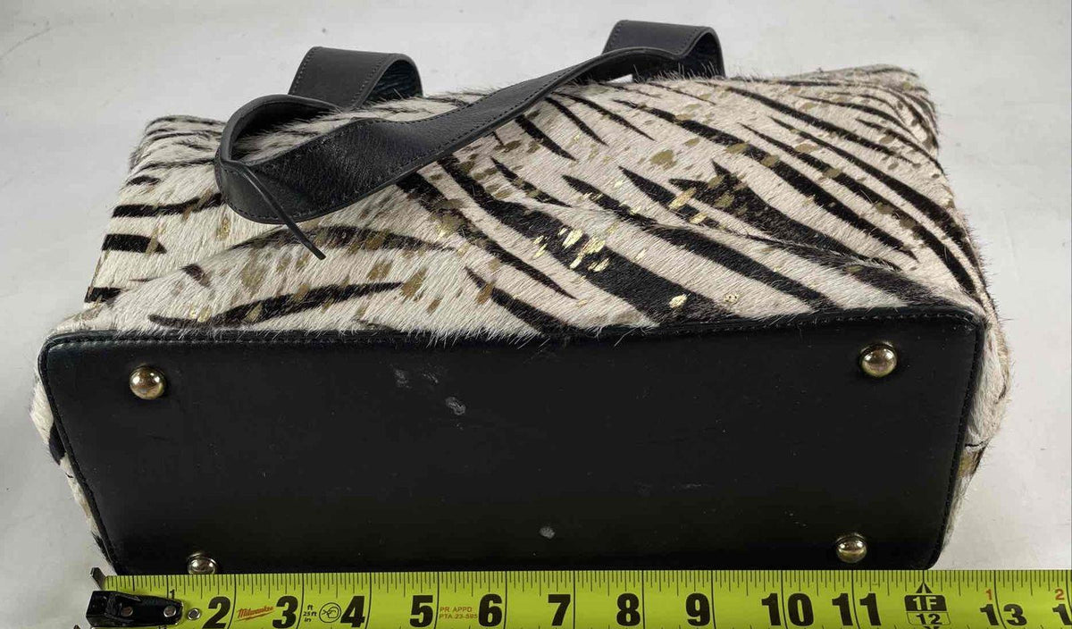 Black and cream zebra print hair-on texture tote with gold splatter and black shoulder straps, view 6