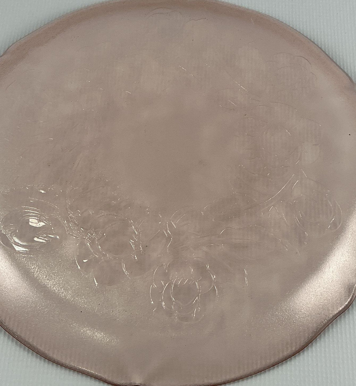 Translucent pink glass platter with scalloped rim and embossed cabbage rose center, view 4