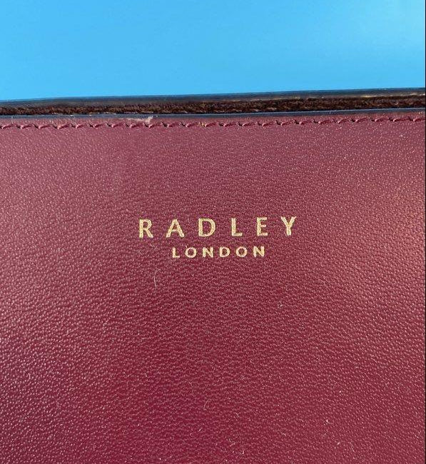 Radley London burgundy leather structured satchel with rolled top handles and patent handle tabs, view 6