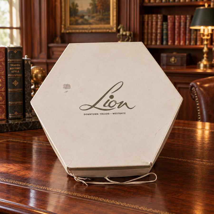 White plush bucket hat with black lining in hexagonal Lion Store Toledo hatbox