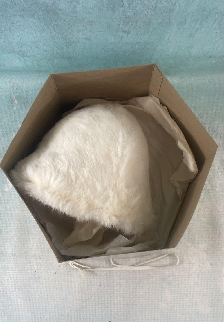 White plush bucket hat with black lining in hexagonal Lion Store Toledo hatbox, view 4