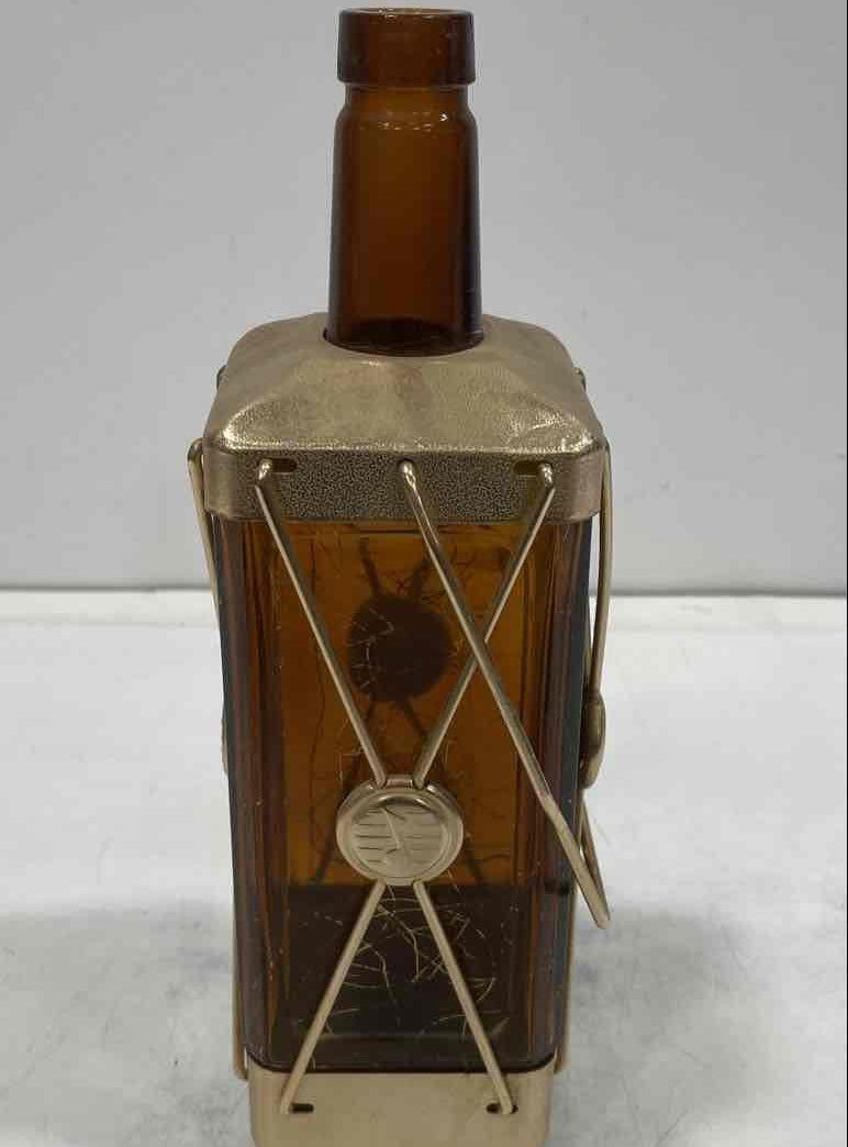 Amber glass decanter labeled Swiss Harmony Musical in a brass-tone wire caddy with medallion, view 3