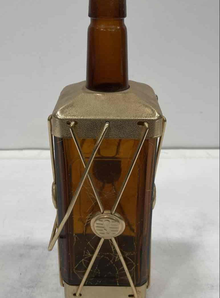 Amber glass decanter labeled Swiss Harmony Musical in a brass-tone wire caddy with medallion, view 5