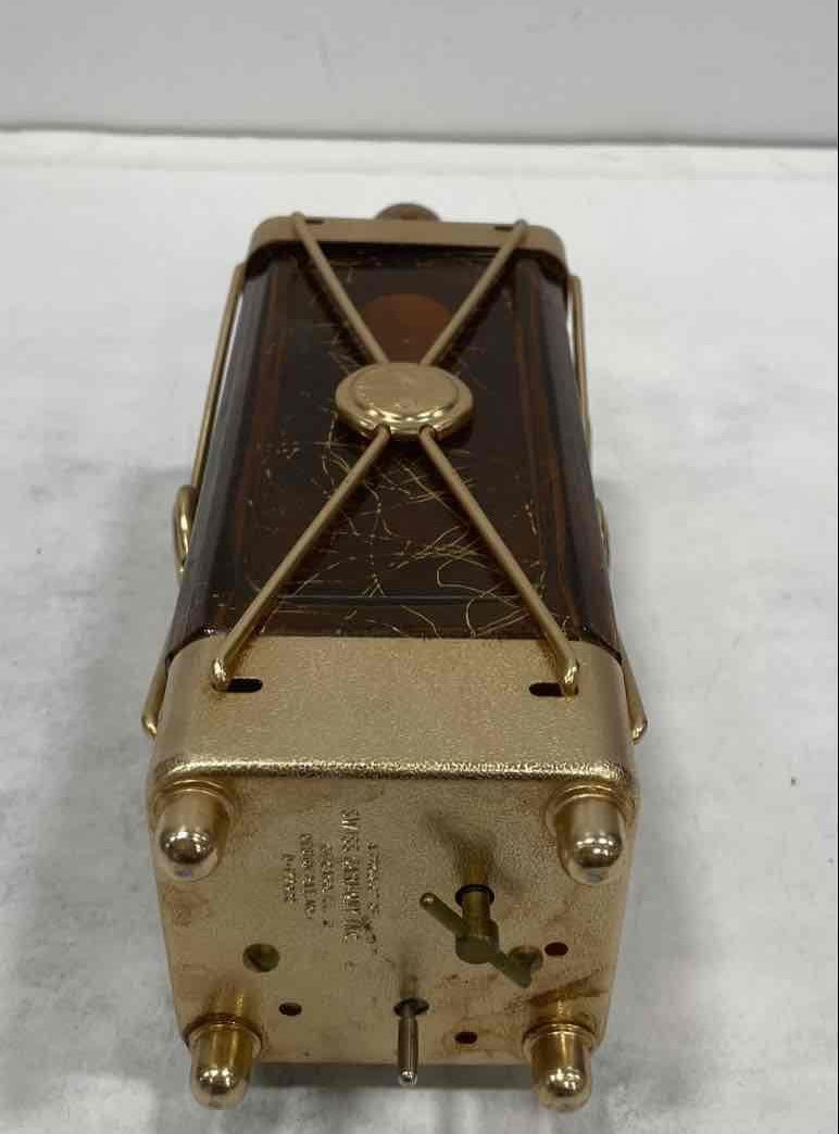 Amber glass decanter labeled Swiss Harmony Musical in a brass-tone wire caddy with medallion, view 6