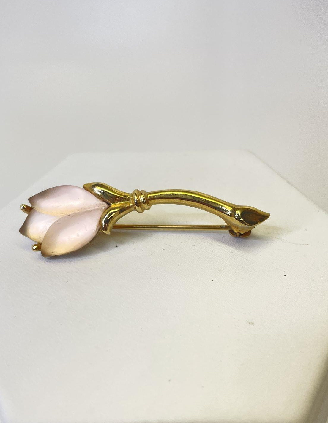 Petite gold-tone flower brooch with two frosted pale pink petals and slender leaf, view 2
