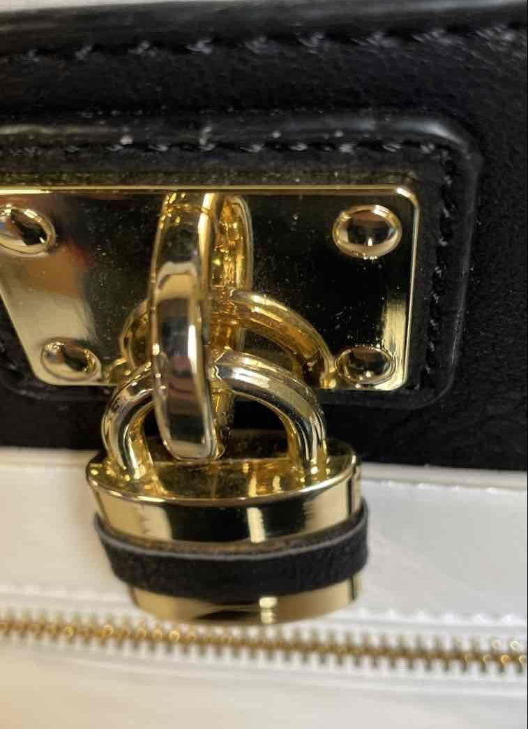 Black and white color block faux leather satchel with gold-tone lock charm and crossbody strap, view 6