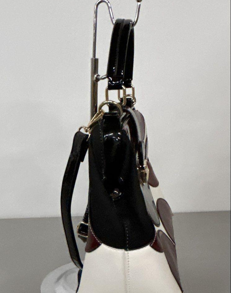 Red, black and white patent-look colorblock frame satchel with circle motifs and top handle, view 3