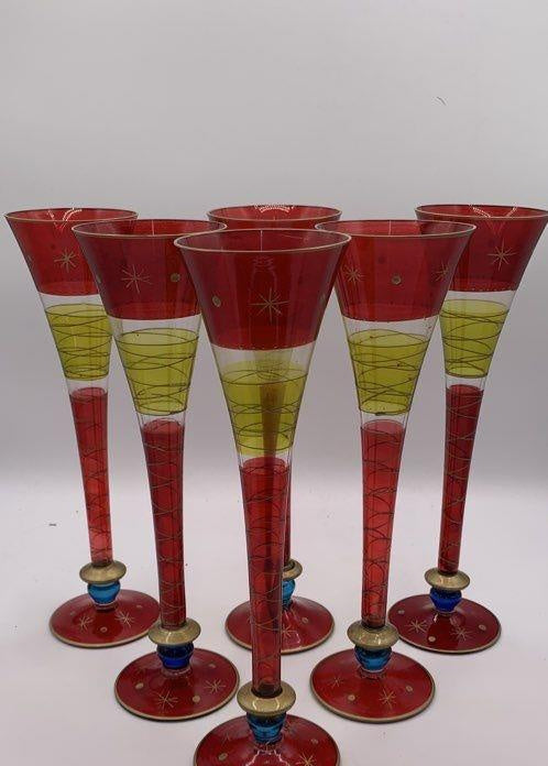 Six tall champagne flutes in ruby red and green with blue knops and gold-tone accents, view 2