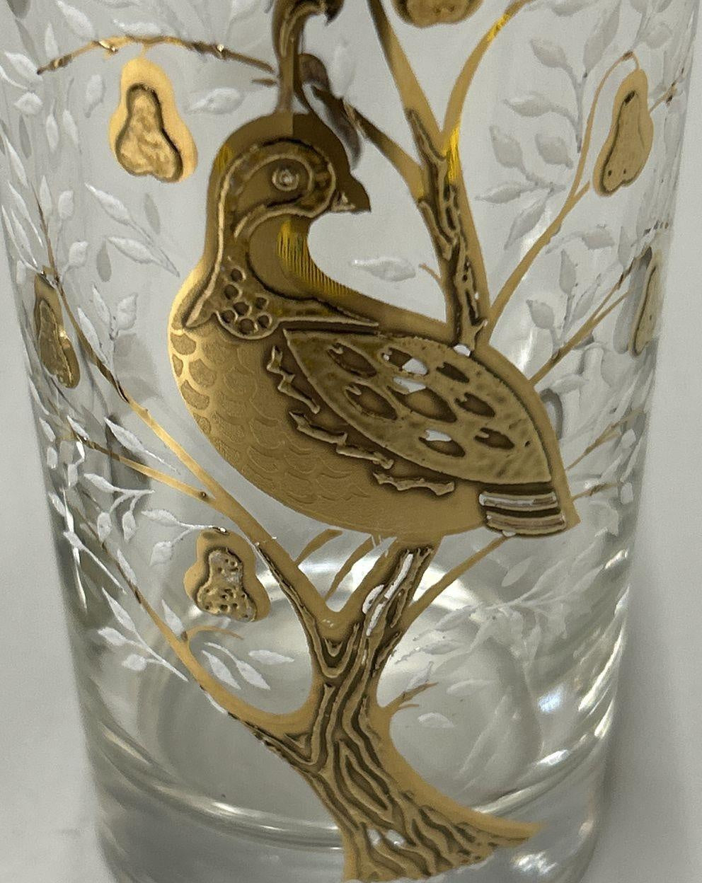 Two clear glass highball tumblers with gold-tone partridge and pear tree design and white foliage, view 3