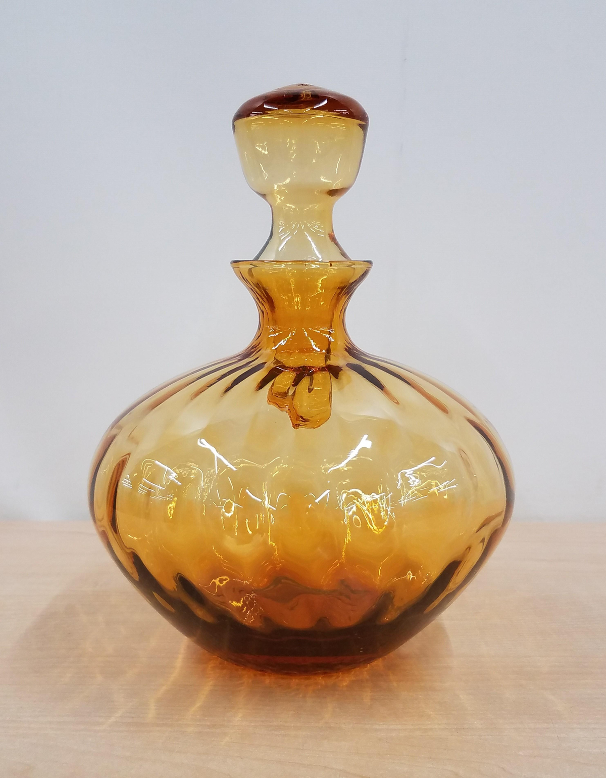 Amber glass decanter with optic ribbed rounded body and faceted stopper, view 2